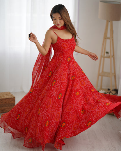 Woman wearing a red dress with floral patterns in a bright room.