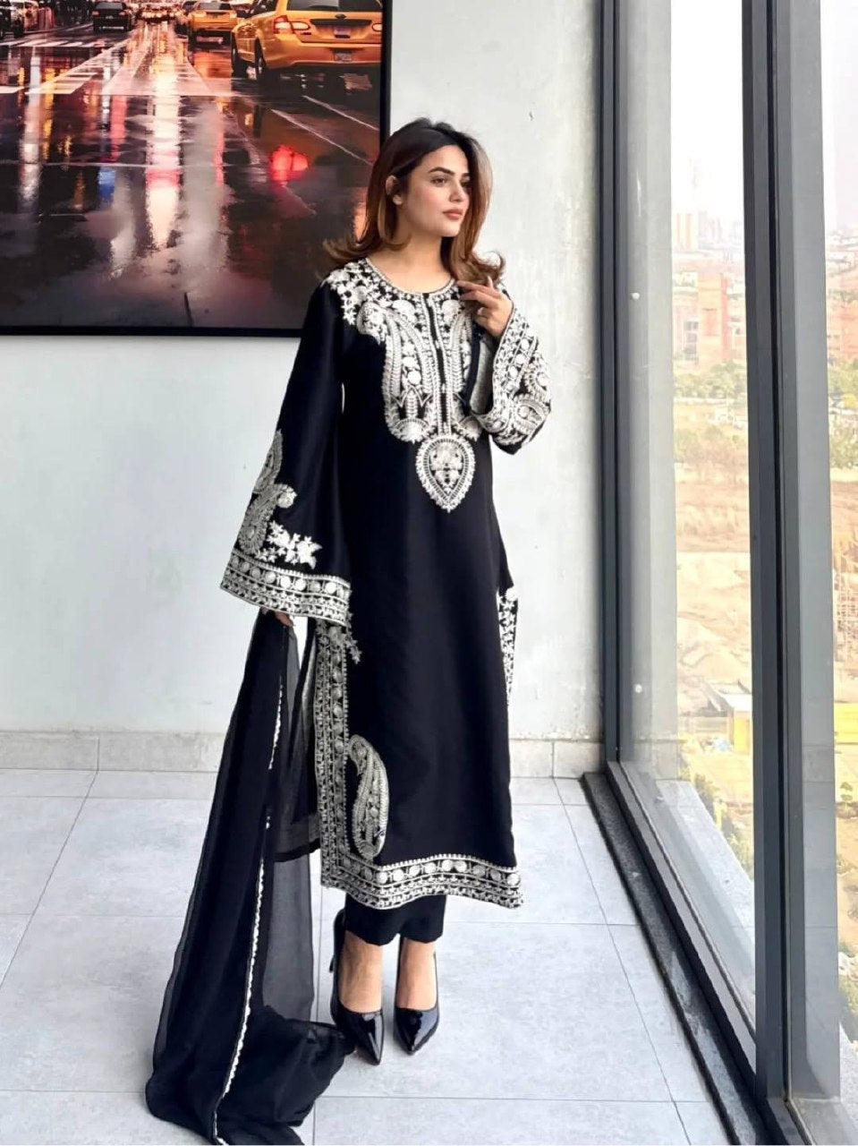 Close-up embroidery work on black organza silk kurta