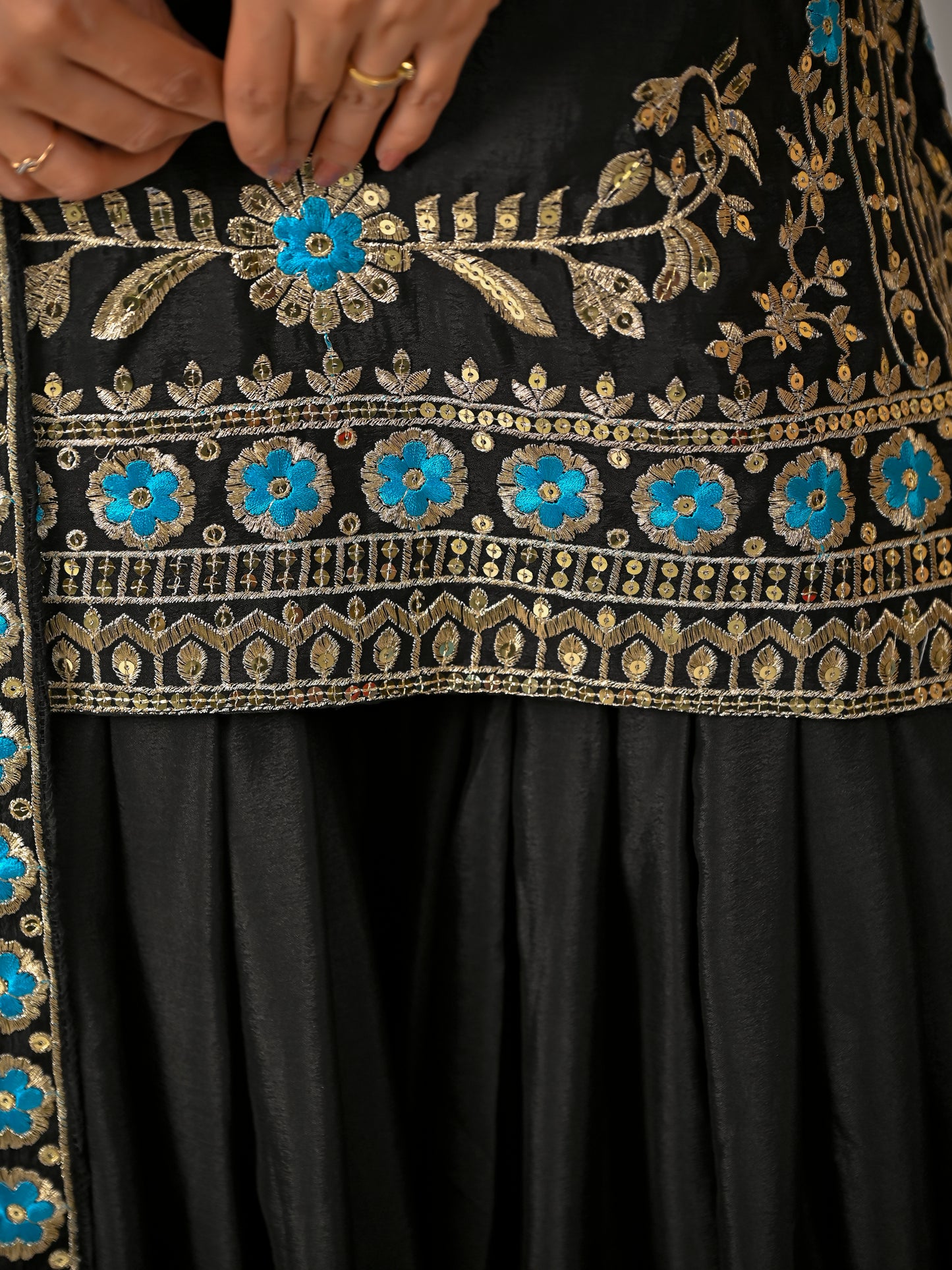 Close up fabric detail of black vichitra silk kurta sharara set with premium texture