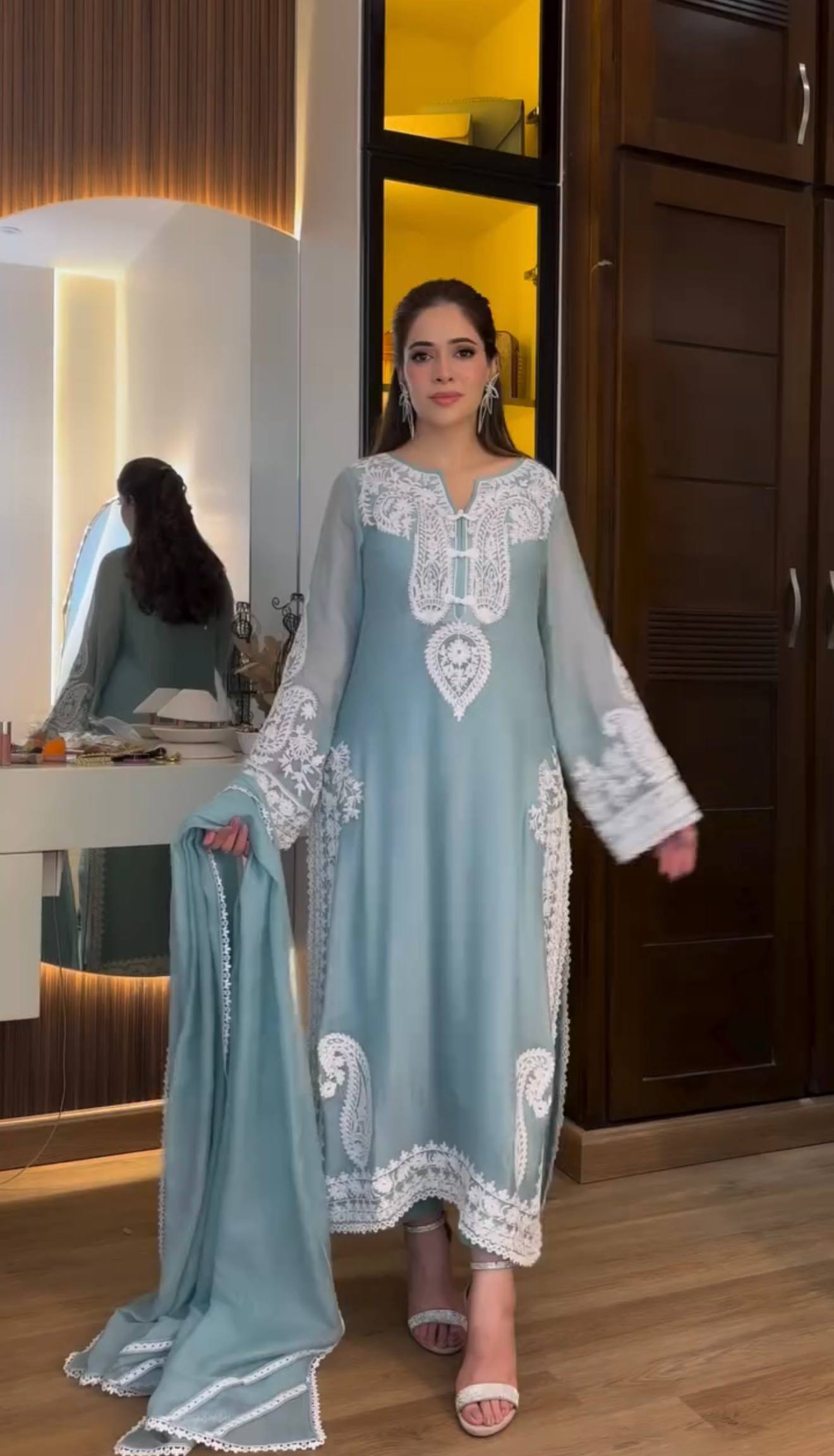 Close-up of fancy bell sleeves and embroidery work on organza silk kurta