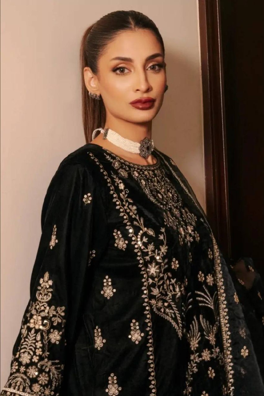 Close-up of embroidered sleeves with detailed sequence work on black satin silk suit