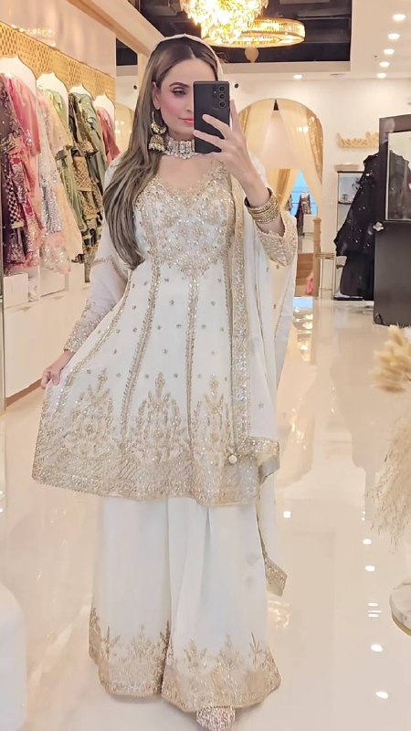 Ivory white Anarkali suit with heavy gold embroidery, elegant ethnic wear for festive and wedding occasions