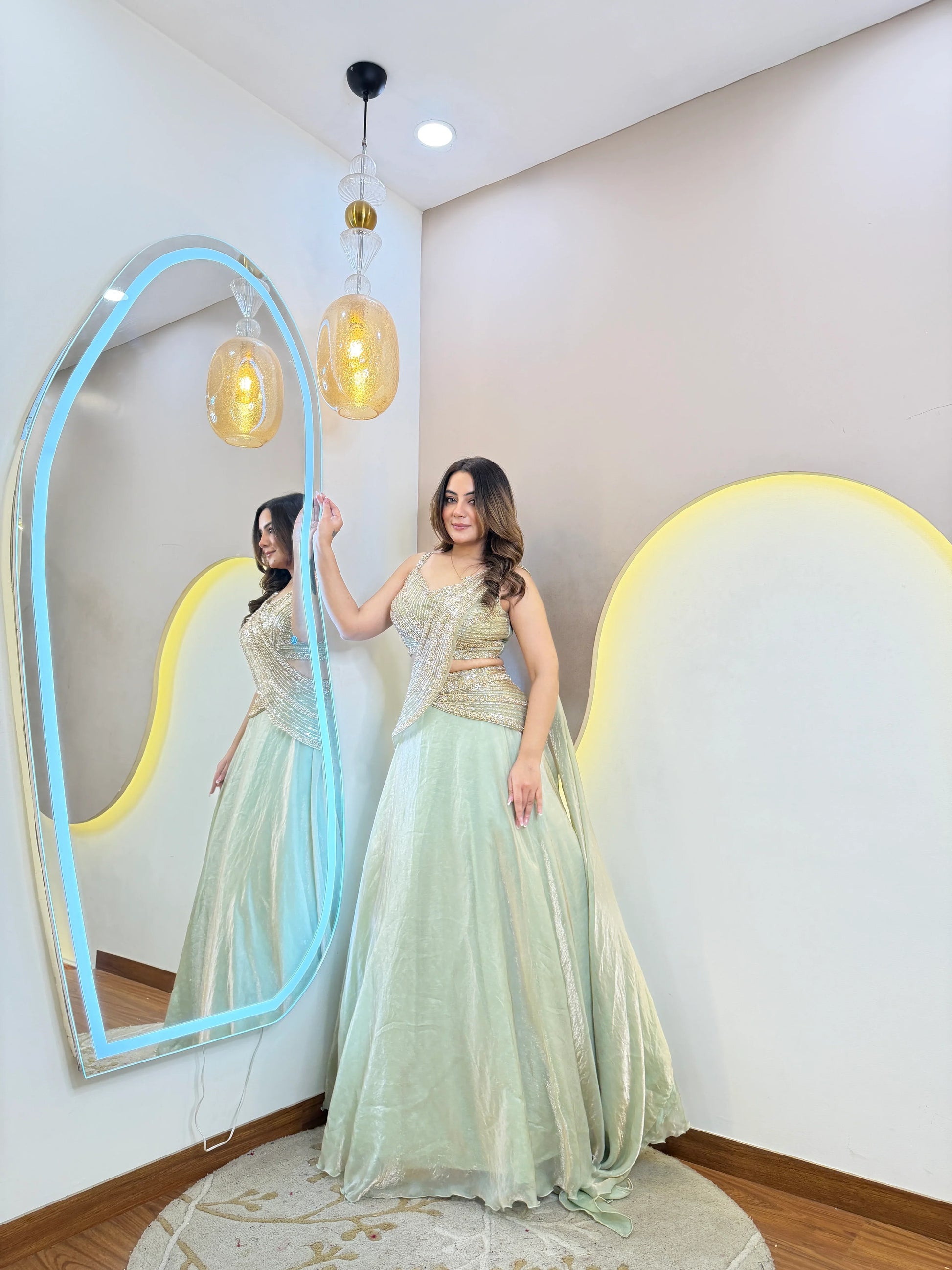 Full length mint green festive lehenga set with elegant embroidery and flowy skirt