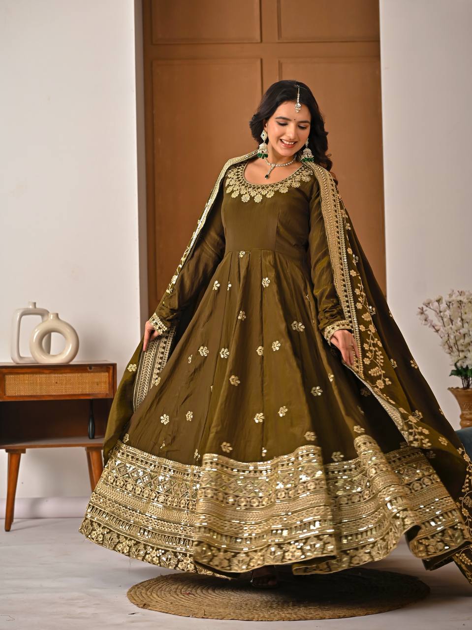 Full length olive green Anarkali gown with detailed embroidery and flared hemline