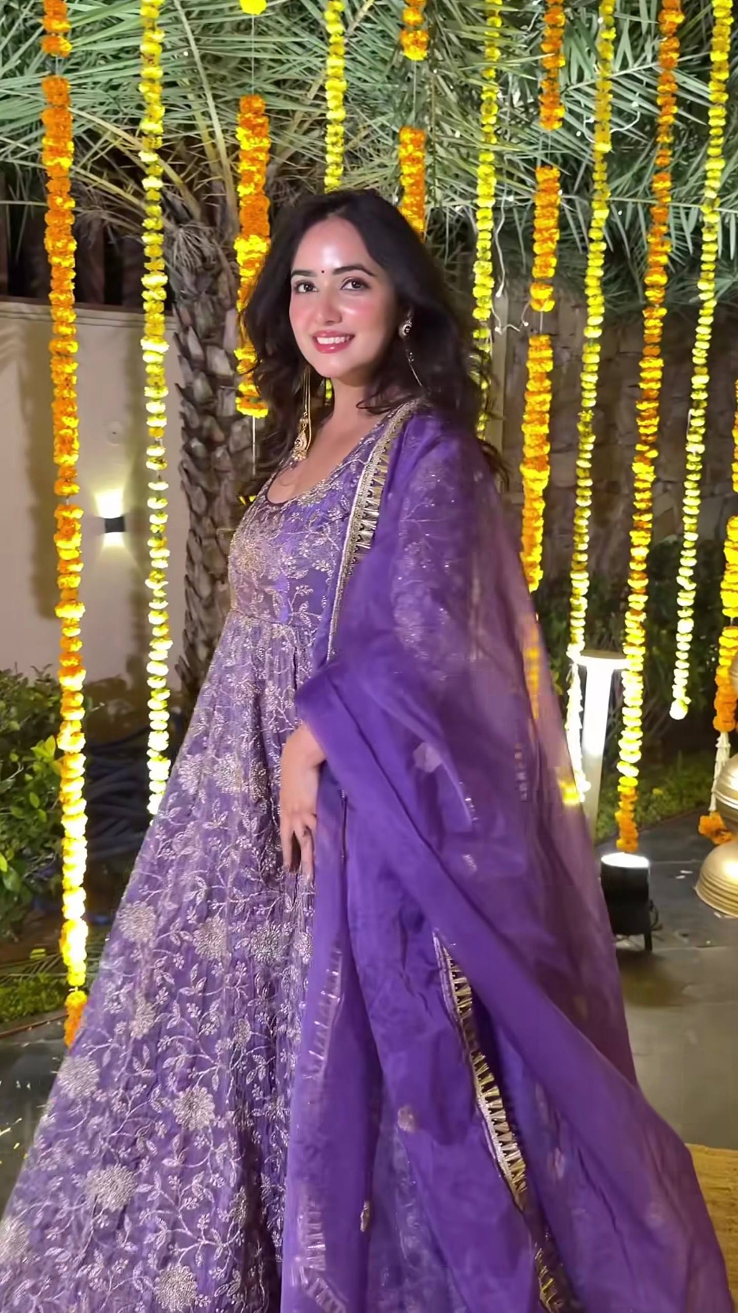 Back view of purple embroidered Anarkali suit with full sleeves and elegant design