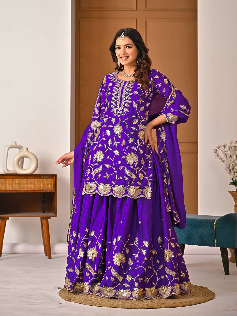 Purple chinnon silk lehenga set showing heavy embroidery work and matching dupatta detail
