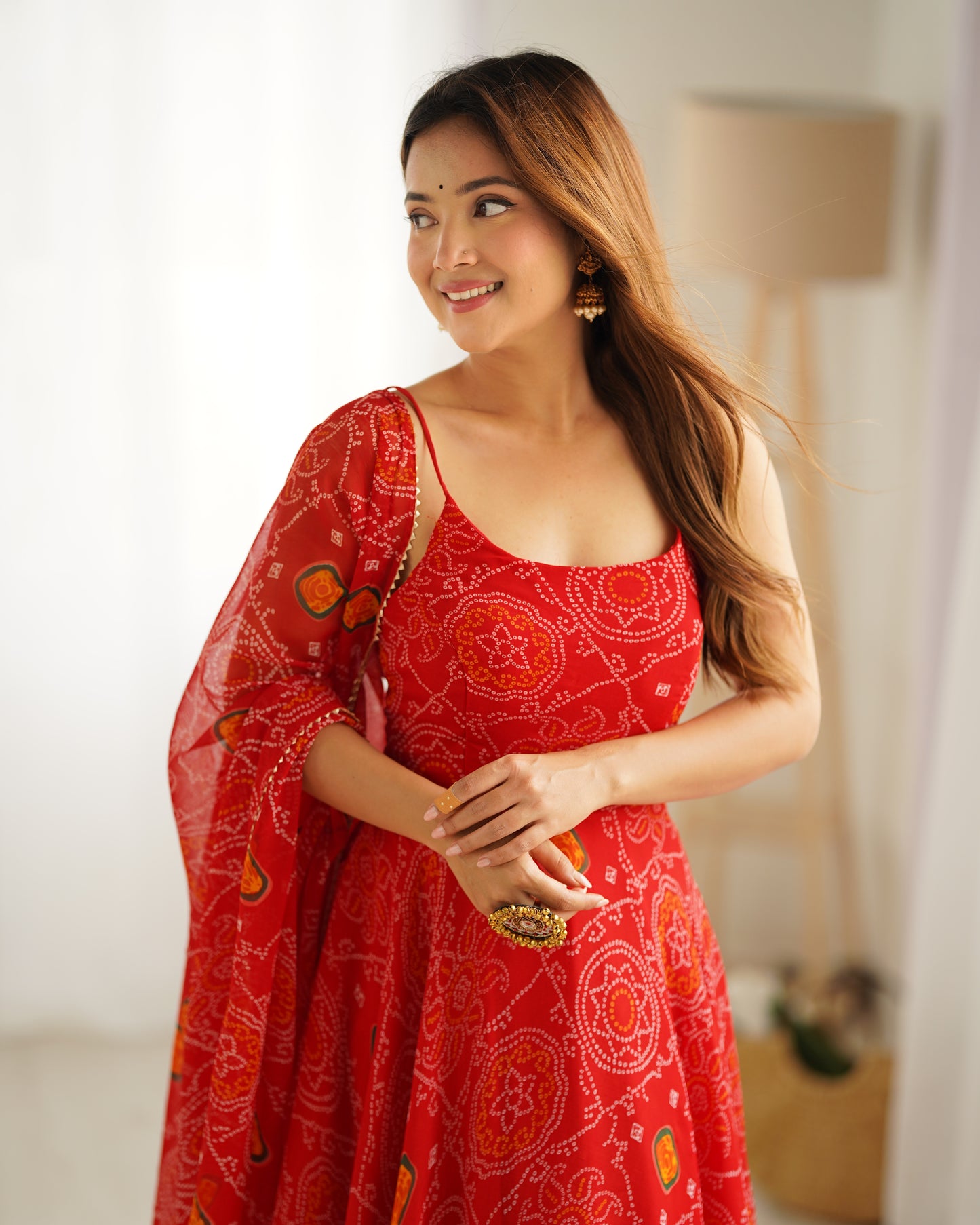 Woman wearing a red dress with patterns indoors