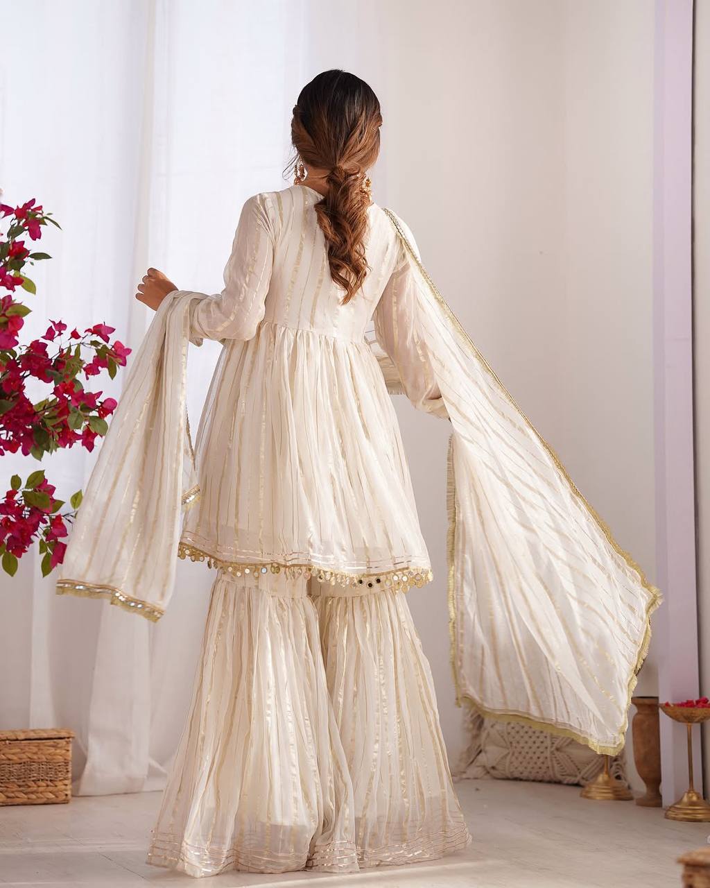 Side view of white sharara suit with golden detailing and dupatta, stylish Indian ethnic wear for women